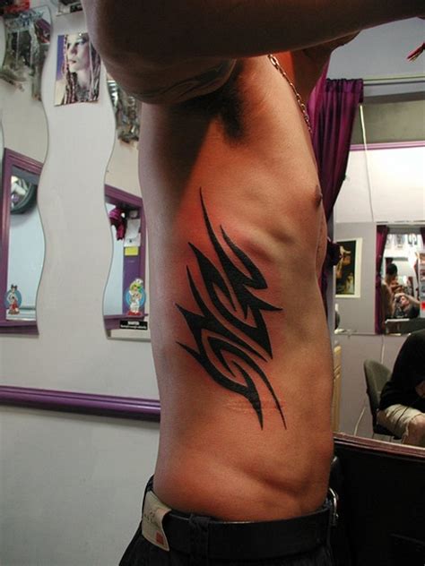 guy tattoos on ribs|tribal rib tattoos for men.